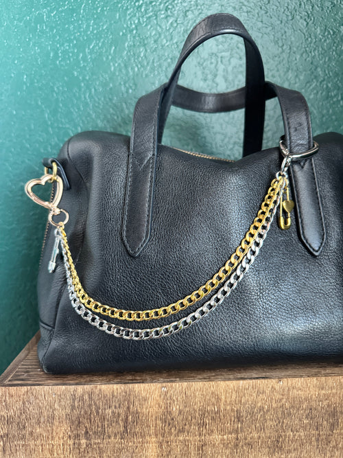 Black leather handbag with gold and silver chain strap