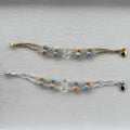 Two beaded bracelets with paperclip chains one in silver and one in gold of Rainbow Alexa Agate gemstones and hand carved clear quartz. 