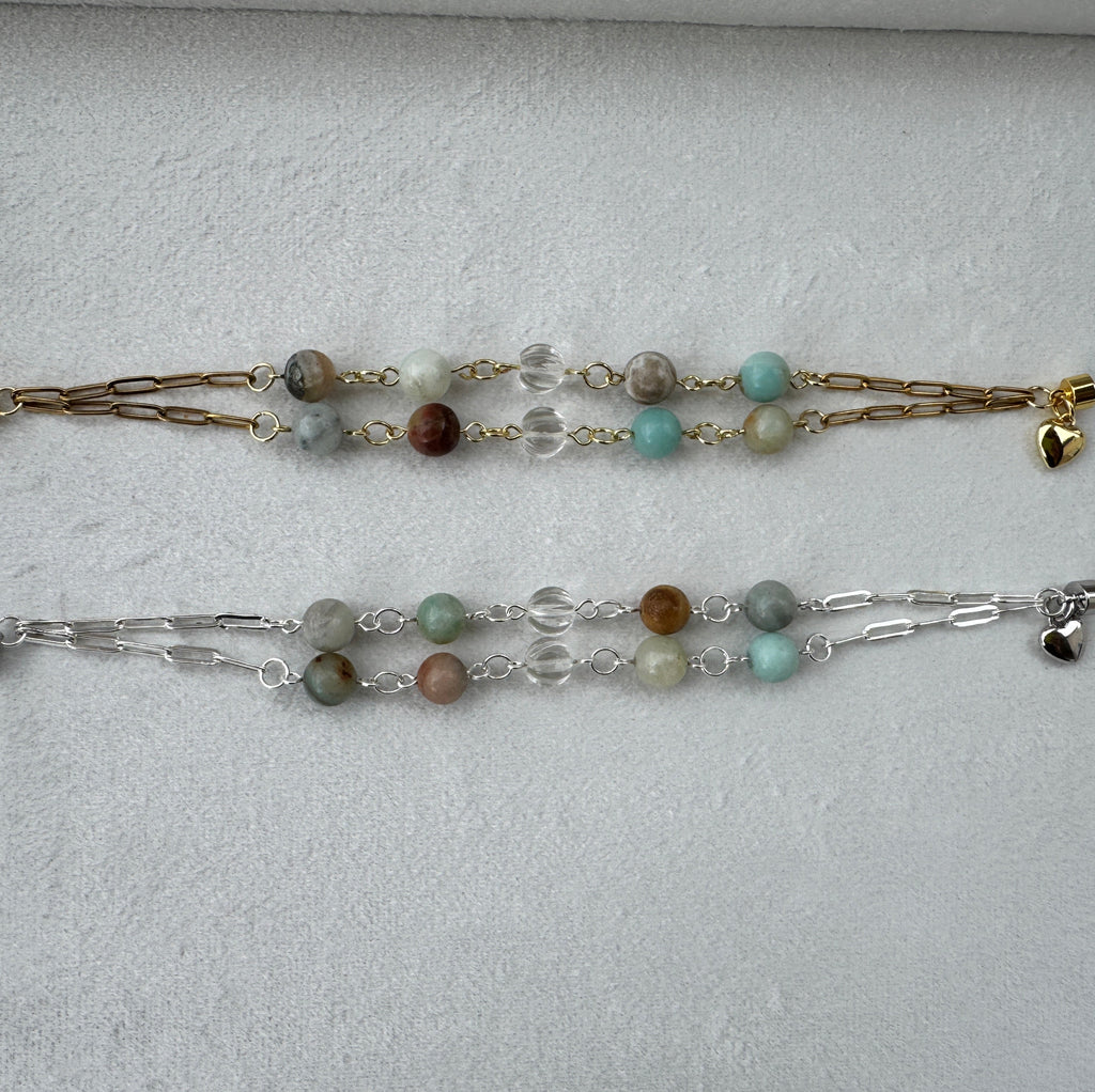 Two beaded bracelets on a light gray surface