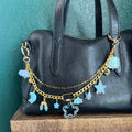 bag chain with blue and gold charms has moon and clouds and star themed charms