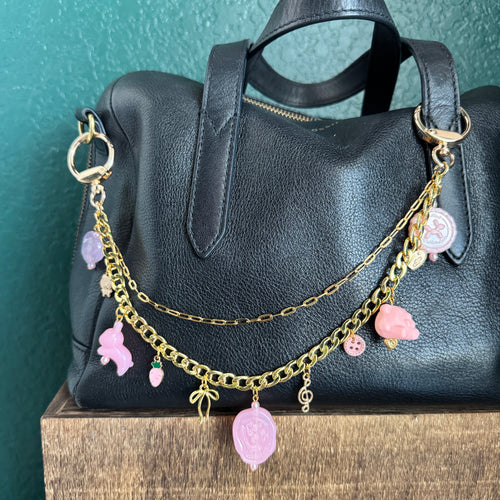 gold chain with pink charms bunny and flowers and miscellaneous charms