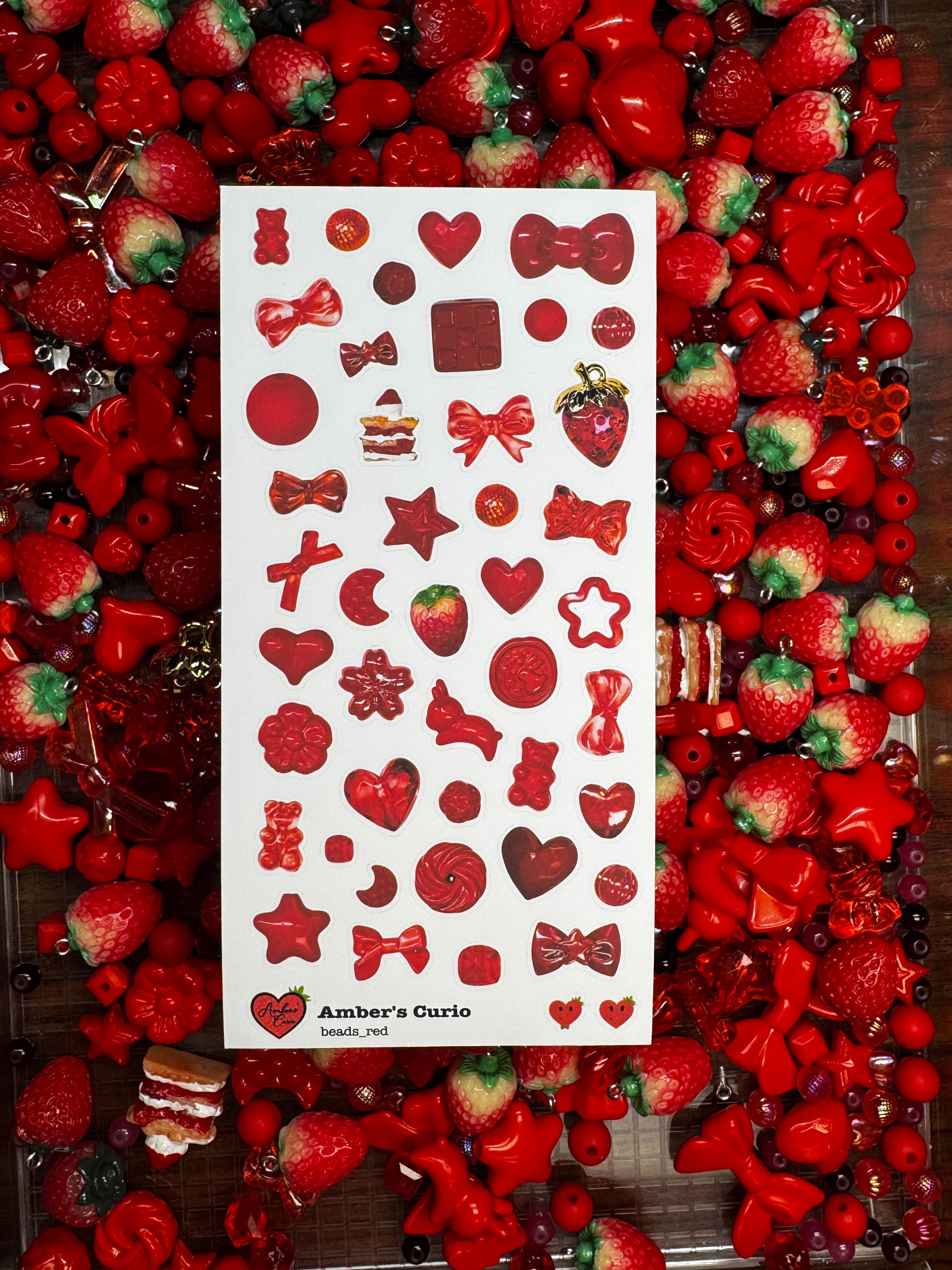 A sticker sheet of photographed red beads printed on premium matte paper photographed on top of beads