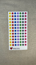 Sheet of colorful emotional faces stickers on a textured gray background
