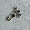 Silver mini charm with a paper clip heart style charm and a book charm 