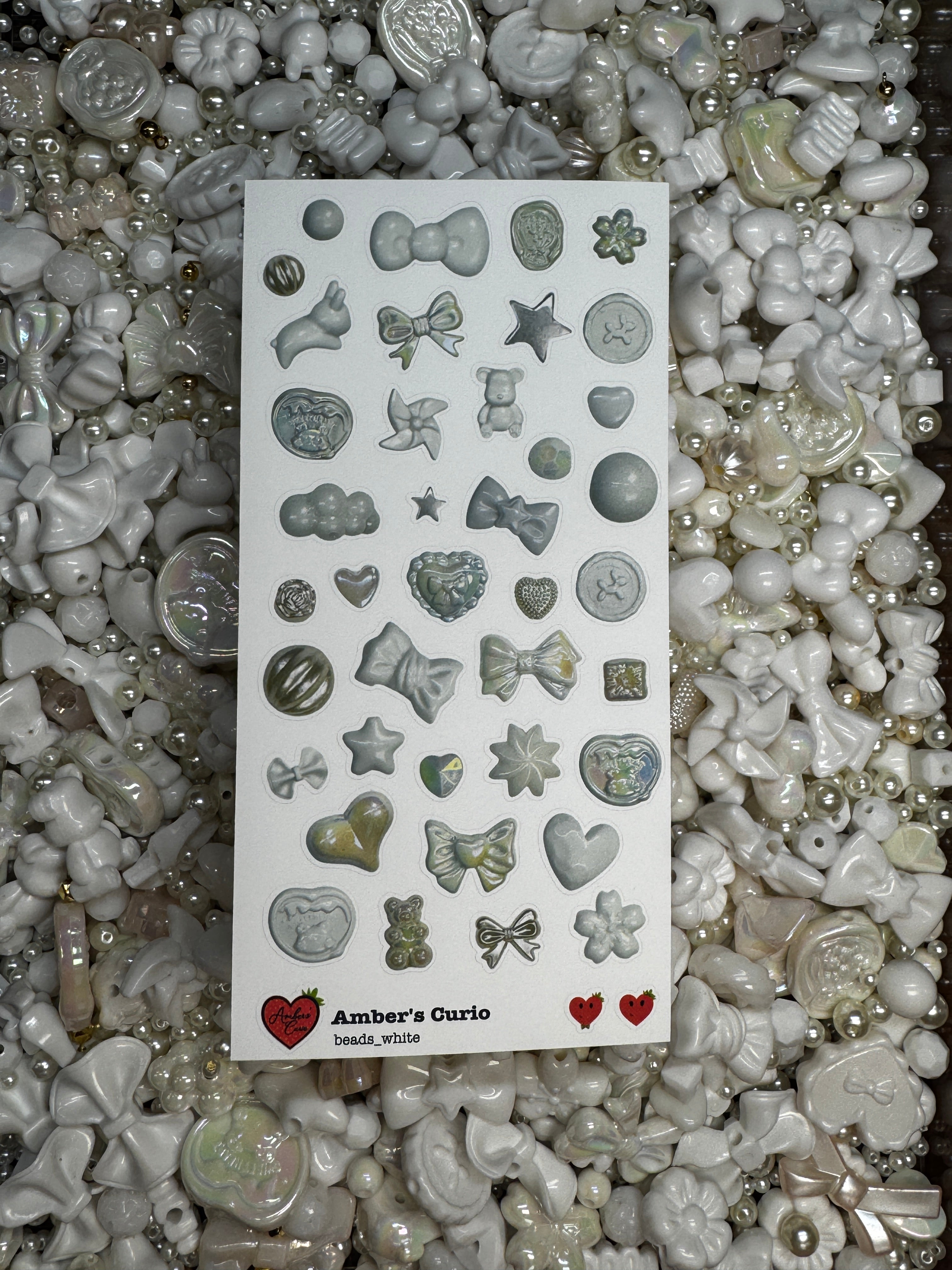 A sticker sheet of photographed white beads printed on premium matte paper photographed on top of beads